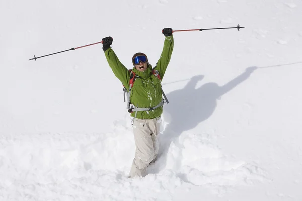 Asian man cheering in snow