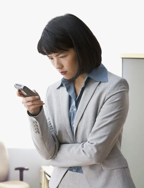 Asian businesswoman looking at cell phone