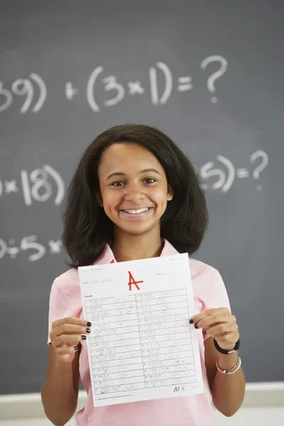 African American girl holding up A paper