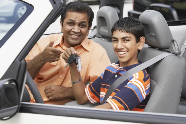 Middle Eastern father and son in new car