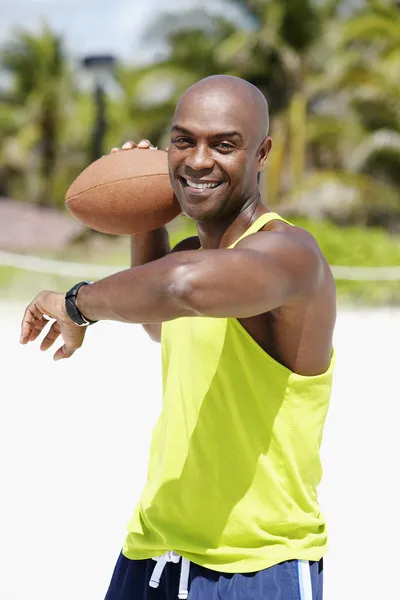 African American man throwing football