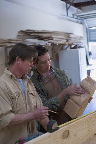 Multi-ethnic men working in wood shop