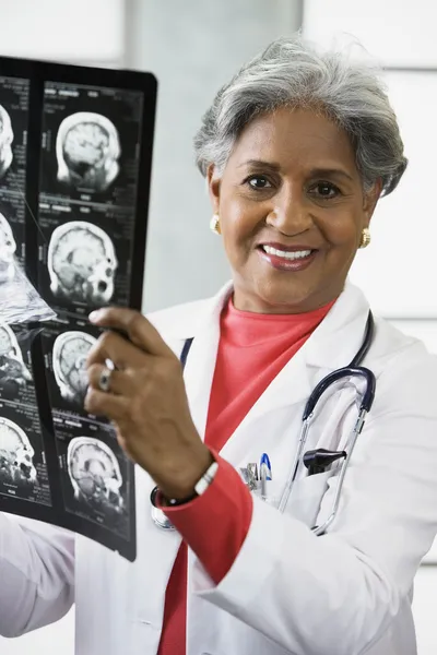 African female doctor looking at x-rays