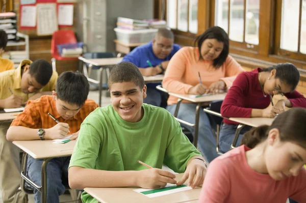 Students making name cards in classroom