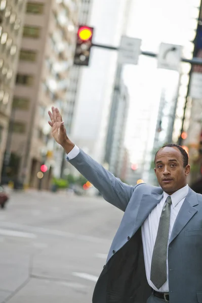 African businessman hailing a taxi