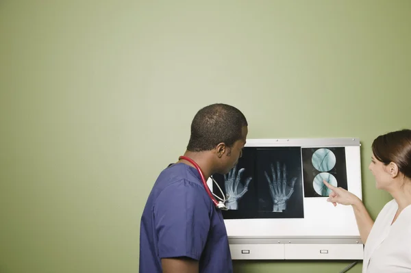 African doctor and nurse examining x-rays