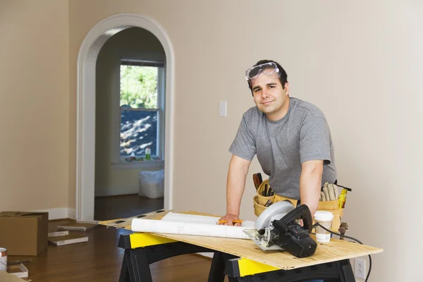 Hispanic man remodeling interior of home