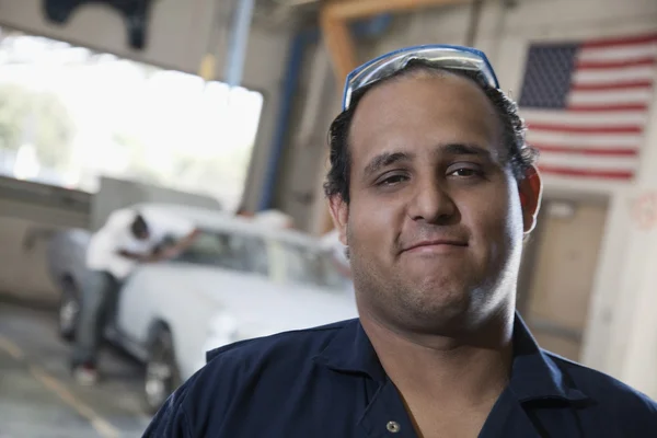 Hispanic worker in auto body shop
