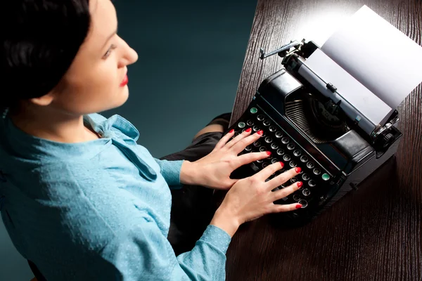 Young woman typing with old typewriter