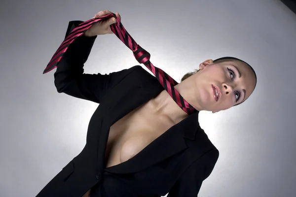 Young sexy woman pulling a tie