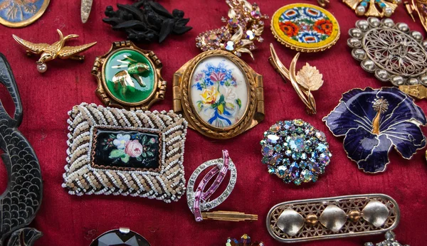 Jewelry background. Vintage brooches at flea market in Paris.