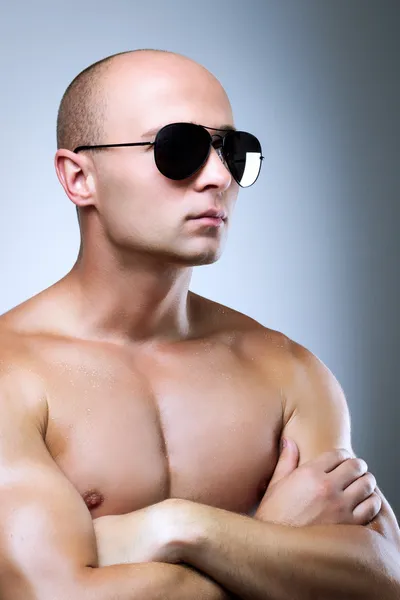 Muscular man with glasses and naked chest