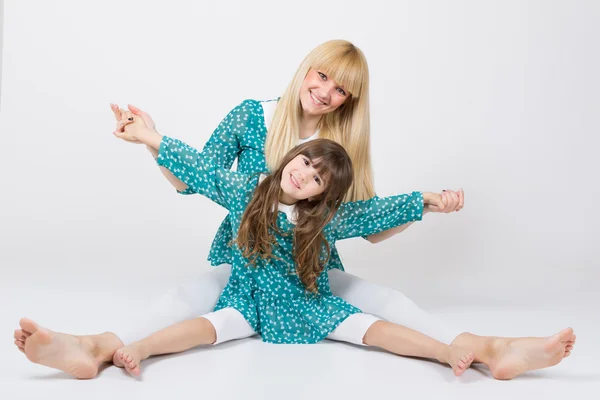 Mother and daughter in matching outfit having fun