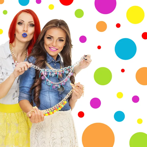 Two trendy young women with colorful necklaces