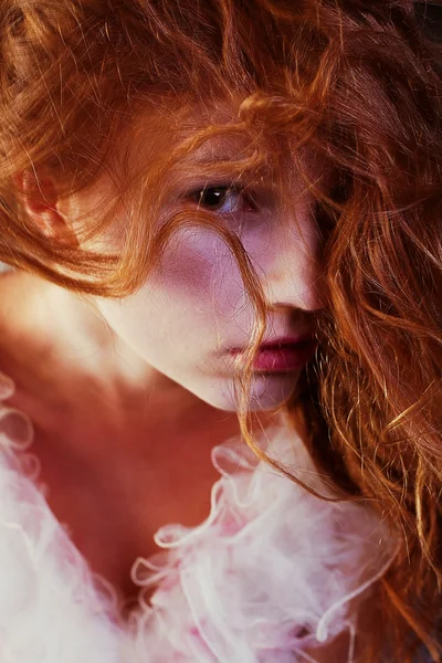 Retro portrait of red-haired queen like girl. studio shot