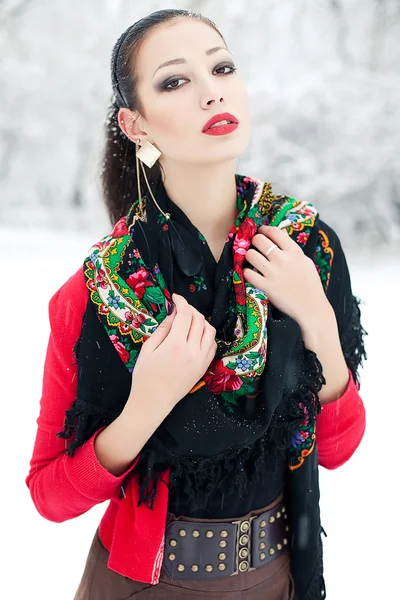 Winter girl in red cardigan with russian kerchief and luxury fas