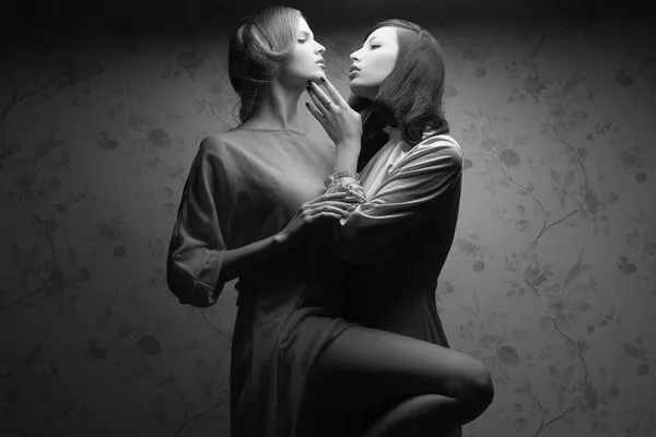 Retro portrait of two gorgeous women (girlfriends) in stylish dr