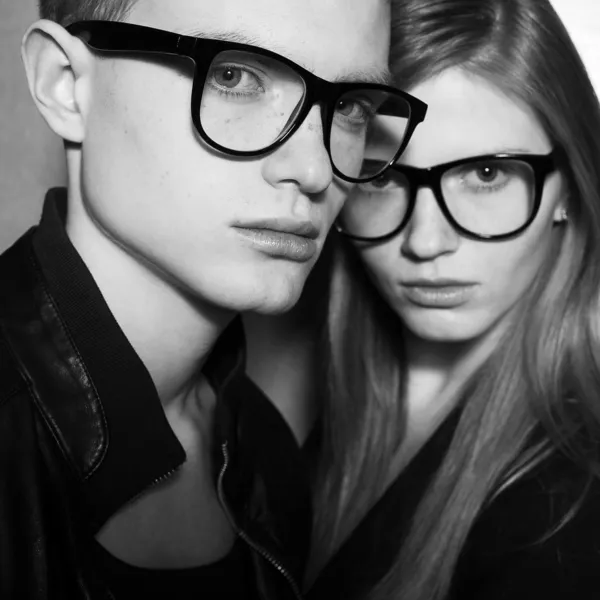 Family portrait of gorgeous blond fashion twins in black clothes