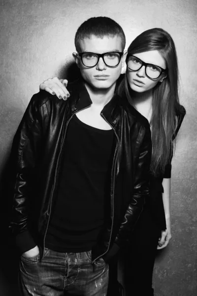 Portrait of gorgeous blond fashion twins in black clothes wearin