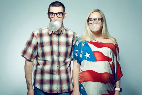 Happy pregnancy concept: portrait of two funny hipsters (husband