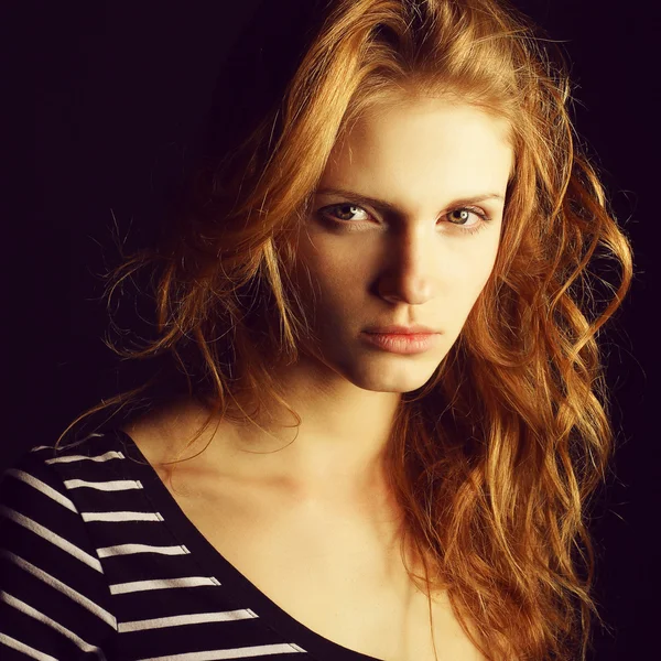 Portrait of a fashionable red-haired (ginger) model in t-shirt w