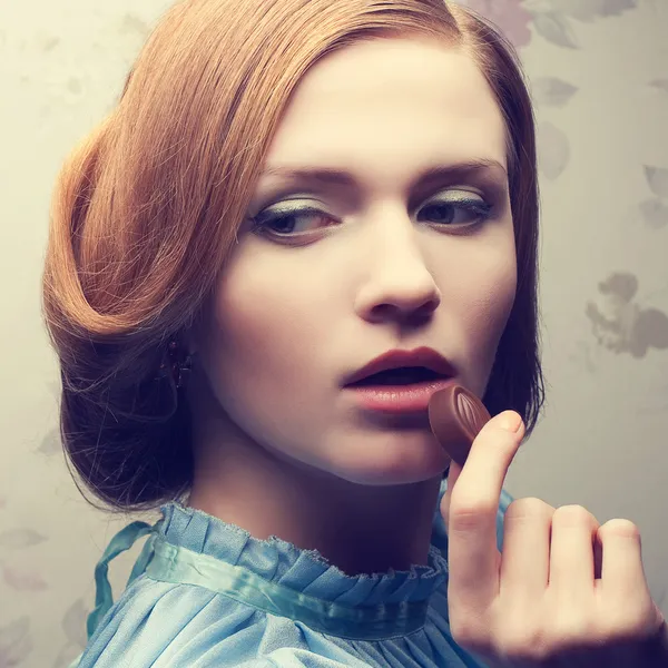 Vintage portrait of a glamorous red-haired (ginger) girl in blue