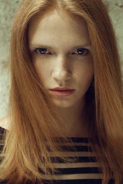 Portrait of beautiful red-haired (ginger) model with freckles