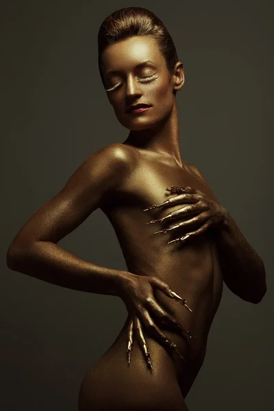 Golden statue of Valkyrie concept. Arty portrait of model with g