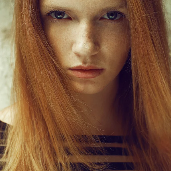 Emotive portrait of a fashionable model with red (ginger) hair a
