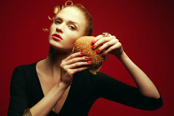 Fashion & Gluttony Concept. Portrait of luxurious red-haired model