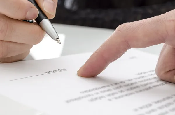 Woman signing a paper