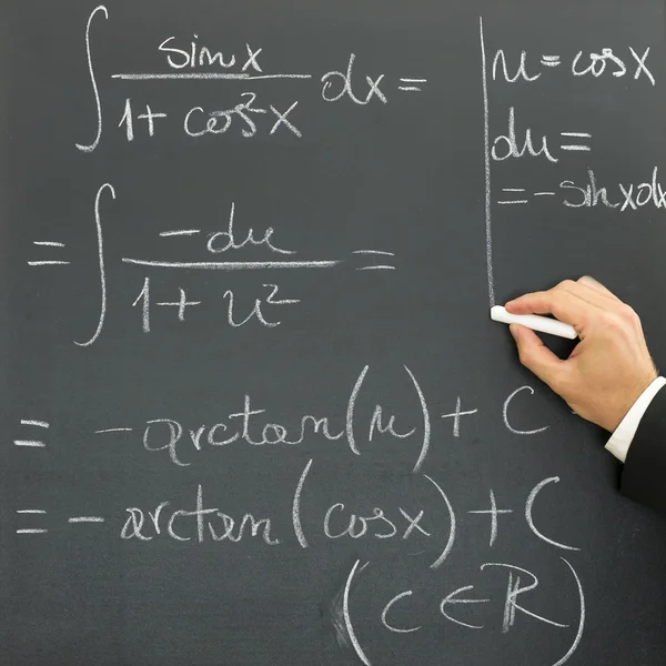 Businessman writing scientific formula