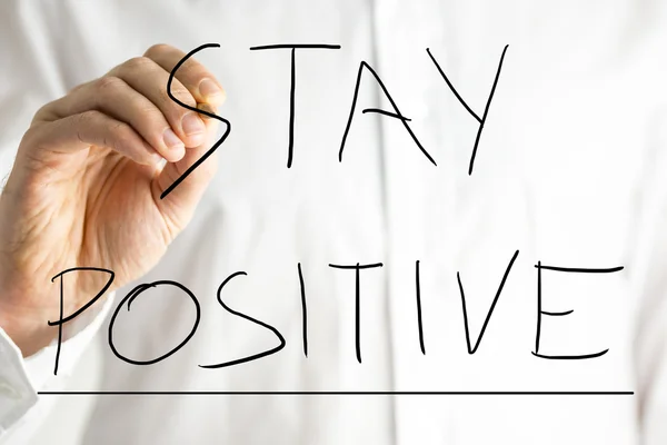 Male hand writing Stay Positive