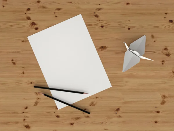Sheet of paper and origami bird on the table