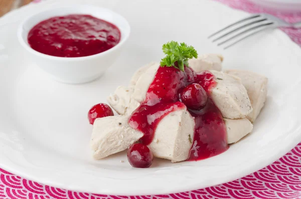 Boiled chicken breast with cranberry sauce closeup horizontal