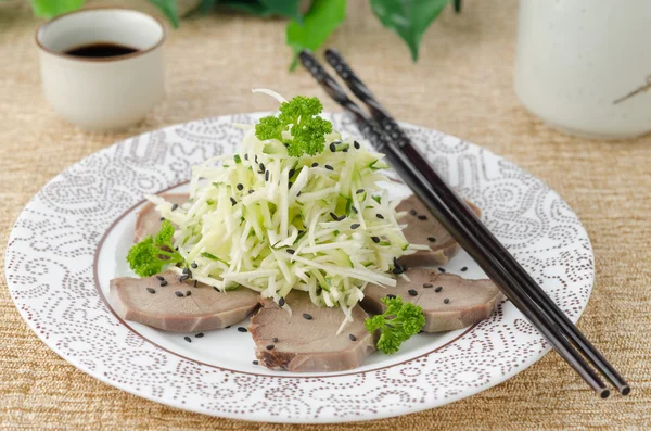 Oriental salad with beef tongue, celery and cucumber