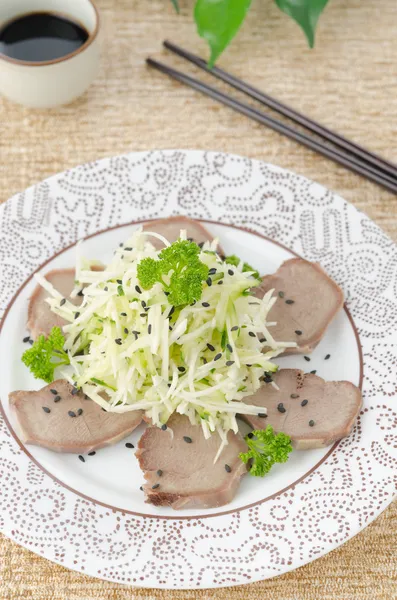 Oriental salad with beef tongue, celery and cucumber top view