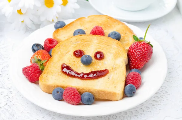 Breakfast with a smiling toast and fresh berries