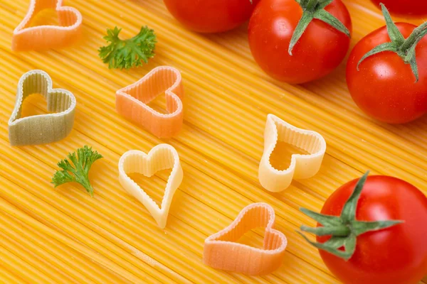 Spaghetti and pasta in the form of heart, selective focus
