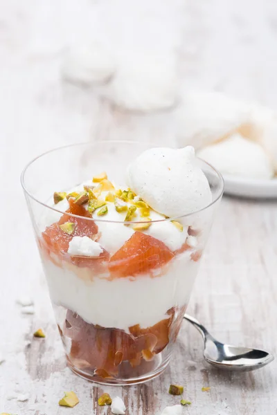 Dessert with canned peaches, whipped cream and meringue