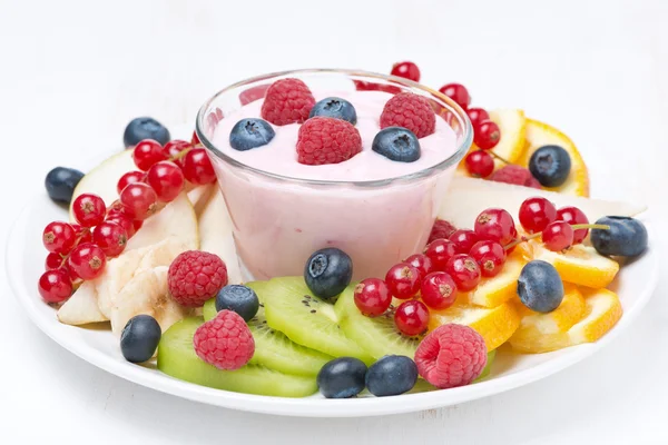 Assorted fresh fruit and berries and fruit yogurt