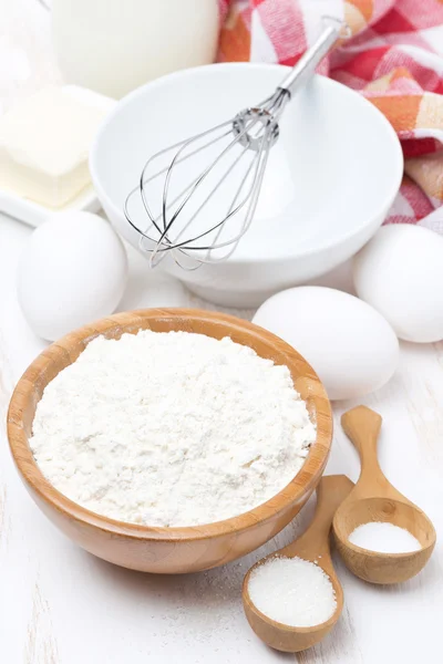 Flour, salt, sugar and eggs for baking pancakes