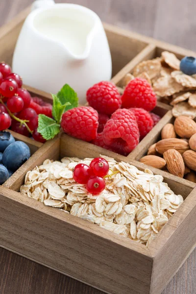 Box with breakfast items - oatmeal, granola, nuts, berries