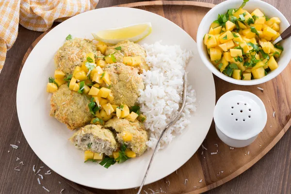 Fish cakes with mango salsa and white rice, top view