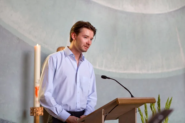 Young man preaching in catholic church