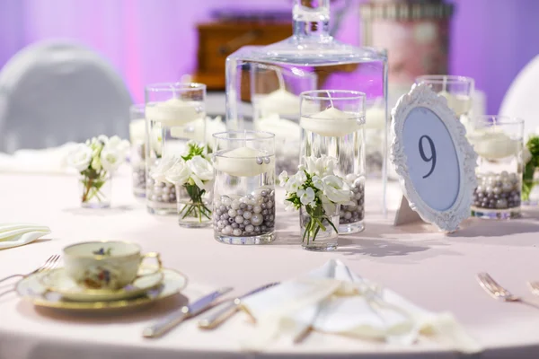 Elegant table set in green and white for wedding or event party.