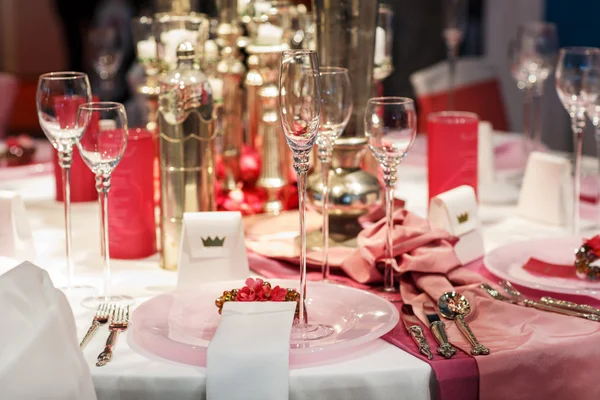 Elegant table set in soft red and pink for wedding or event part