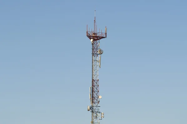CELL PHONE TOWER ON A BLUE SKY