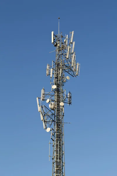 CELL PHONE TOWER ON A BACKGROUND SKY