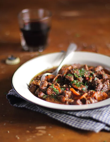 Traditional irish beef stew with carrot, onion and guinness beer in a plate ready for family lunch or dinner